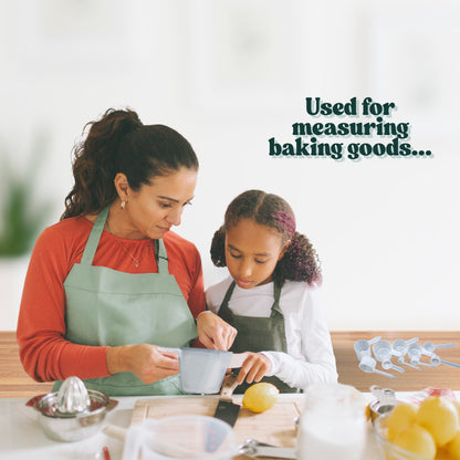 A mother and daughter using PP plastic measuring scoops to measure dry ingredients together while baking in the kitchen.
