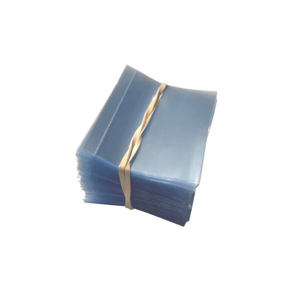 A stack of clear PVC plastic perforated shrink bands, measuring 55 x 56 mm.